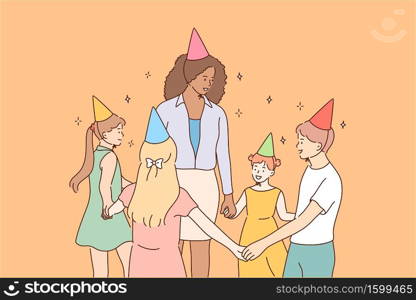 Entertainment, holiday, education, celebration, childhood concept. Young smiling african american woman teacher character leads roundelay with children kids pupils in kindergarten celebrating birthday. Entertainment, holiday, education, celebration, childhood concept