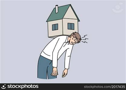 Exhausted young man carry house on back suffer from bank mortgage or lease burden. Tired male struggle with financial payment, home expenses, bills and taxes. Flat vector illustration.. Tired man lean under house maintenance burden