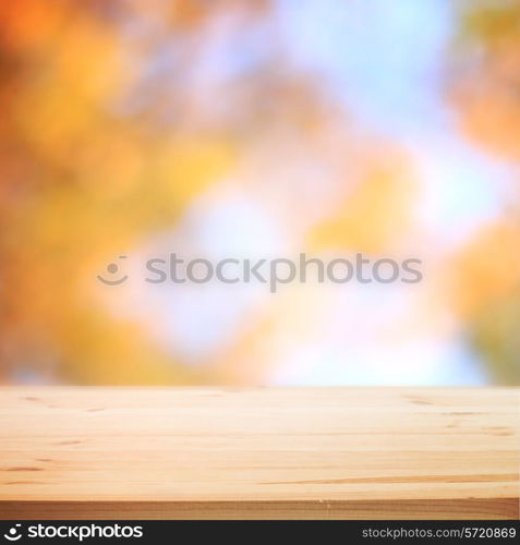 Fall blurred background with wooden table for your design. Vector illustration.