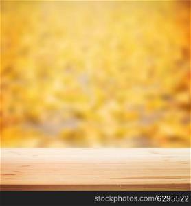 Fall blurred background with wooden table for your design. Vector illustration.