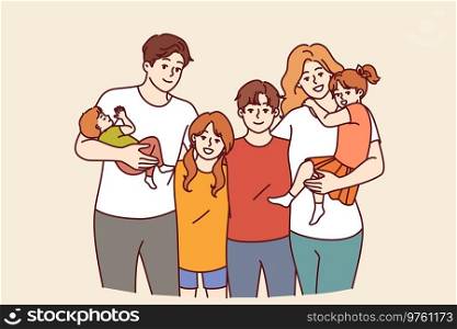 Family from teenagers and toddlers with mom and dad posing together for family portrait. Concept of guardianship of children left without parents or assistance to boys and girls from orphanages. Family from teenagers and toddlers with mom and dad posing together for family portrait