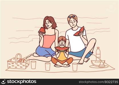 Family sitting on seashore, eating watermelon and relaxing on sunny beach in hot summer weather. Young family of boy and parents had picnic on tropical island during trip to resort. Family sitting on seashore, eating watermelon and relaxing on sunny beach in hot summer weather