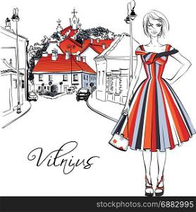 Fashionable girl in Old Town of Vilnius, Lithuania. Vector color hand drawing. Cute beautiful fashion girl in summer dress on typical street in Old Town of Vilnius, Lithuania.