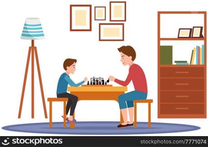 Father and little son sitting at table and playing chess in living room. Person holding in hand chess figure. Dad and boy spend time together and have fun. Family playing strategy logic game at home. Father and little son sitting at table and playing chess in living room. Dad and boy have fun