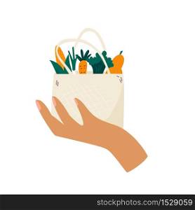 Female hand holding reusable eco bag with organic vegetables. Zero waste concept. Female hand holding reusable eco bag with organic vegetables.