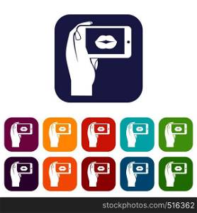 Female hand holding smartphone with picture of lips icons set vector illustration in flat style in colors red, blue, green, and other. Female hand holding smartphone