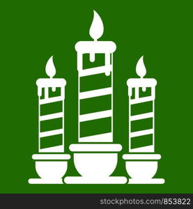 Festive candles icon white isolated on green background. Vector illustration. Festive candles icon green