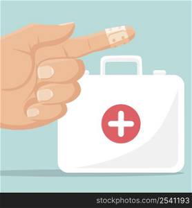 First aid kit and a finger with an adhesive bandage
