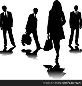 four business people in silhouette walking in different directions