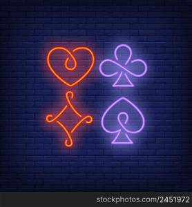 Four playing card suit symbols neon sign. Gambling and poker club design. Night bright neon sign, colorful billboard, light banner. Vector illustration in neon style.