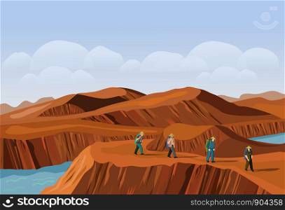 Four tourists are walking on the desert mountain. There are brown mountains and cubes in the background.