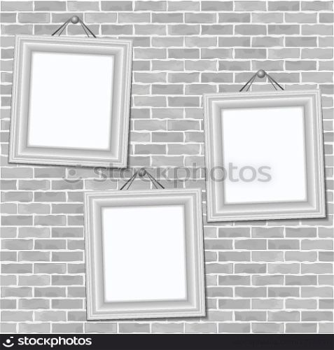 Frames hanging on a brick wall