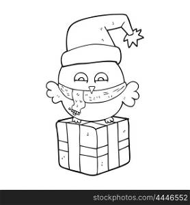 freehand drawn black and white cartoon cute christmas owl on wrapped present