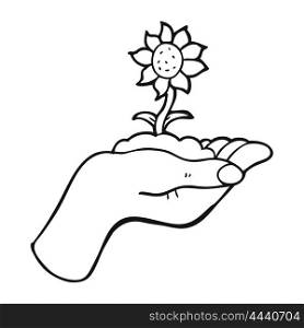freehand drawn black and white cartoon flower growing in palm of hand