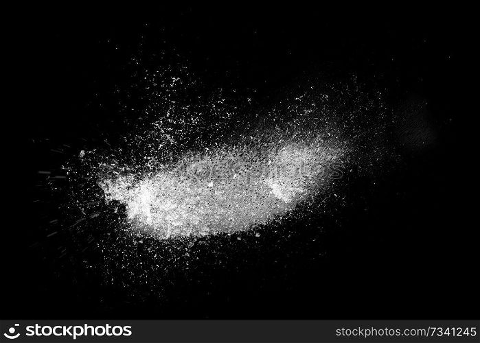 Freeze motion of white powder exploding, isolated on black, dark background. Abstract design of dust cloud. Particles explosion, screen saver wallpaper with copy space. 