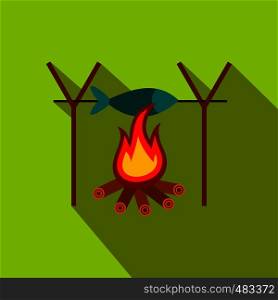 Fresh fish above fire flat icon on a green background. Fresh fish above fire flat icon