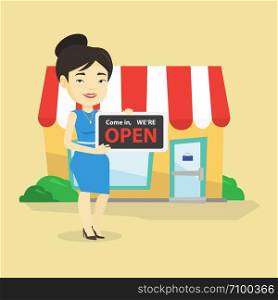 Friendly female shop owner holding open signboard. Cheerful female shop owner standing in front of small store. Woman inviting to come in her shop. Vector flat design illustration. Square layout.. Female shop owner holding open signboard.