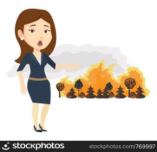 Frustrated woman standing on the background of a big forest fire. Woman pointing at forest in fire. Concept of environmental destruction. Vector flat design illustration isolated on white background.. Woman standing on background of wildfire.