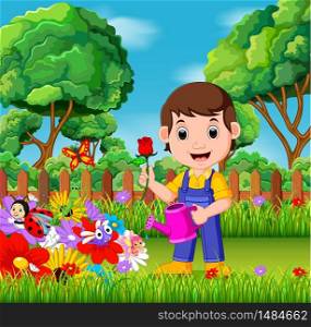 gardener holding flower and watering can in a flower garden