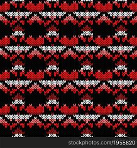 Geometrical ornate seamless knitted vector pattern as a fabric texture in red, pink, black and white colors