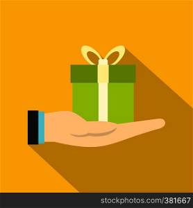 Gift box in hand icon. Flat illustration of gift box in hand vector icon for web design. Gift box in hand icon, flat style