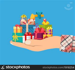Gift boxes in hand. Colorful wrapped. Sale, shopping. Present boxes different sizes with bows and ribbons. Collection for birthday and holiday. Vector illustration in flat style. Gift boxes in hand. Colorful wrapped.