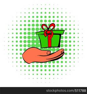 Gift red box in a hand icon in comics style on a white background. Gift red box in a hand icon, comics style