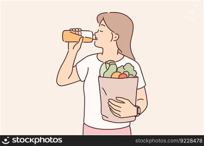 Girl drinks freshly squeezed juice and holds bag filled with vegetables from farmer market for making diet salads. Concept detox and proper nutrition for vegans and vegetarians using organic diet . Girl drinks freshly squeezed juice and holds bag filled with vegetables from farmer market