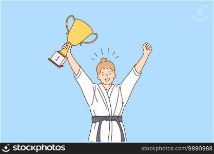 Girl karate fighter and winner concept. Smiling happy girl in white kimono with belt karate fighter standing with golden trophy in hands and celebrating victory feeling confident . Girl karate fighter and winner concept