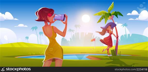 Girl take photo of friend on golf course. Vector cartoon illustration of summer tropical landscape with sport field, pond, palm trees and women posing and photographing on mobile phone camera. Girl take photo of woman on golf course