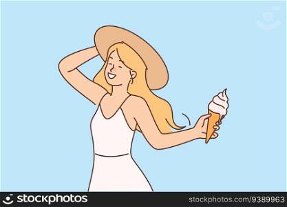 Girl with ice cream in waffle cone enjoys summer holidays and hot sunny weather. Happy young woman in summer dress and hat eats cold ice cream with creamy flavor to refresh herself after walk. Girl with ice cream in waffle cone enjoys summer holidays and hot sunny weather.