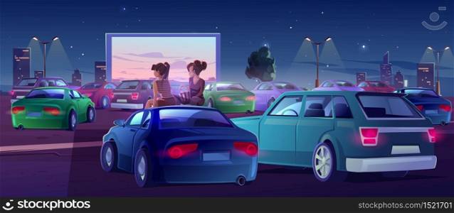 Girls at car cinema. Couple of friends in drive-in theater with automobiles stand in open air city parking at night. Women sit on auto roof watching movie, eating popcorn, Cartoon vector illustration. Girls at car cinema, friends in drive-in theater