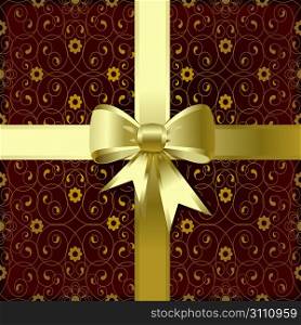 Gold christmas bow on a brown background