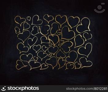 Gold hearts on dark textured black backdrop