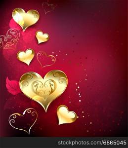 gold, jewelry hearts on red textural background with leaves of roses