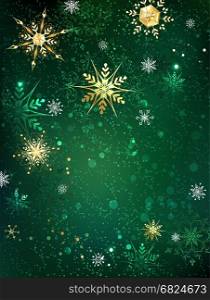 gold jewelry snowflakes on green textural background