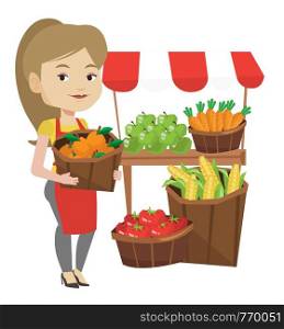 Greengrocer standing near stall with fruits and vegetables. Greengrocer standing near market stall. Greengrocer holding basket with fruits. Vector flat design illustration isolated on white background. Street seller with fruits and vegetables.