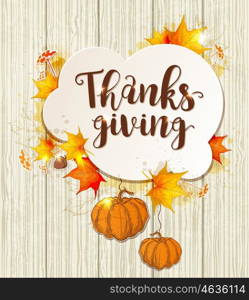 Greeting card for Thanksgiving Day. Lettering, orange pumpkins and maple leaves on a wooden background.