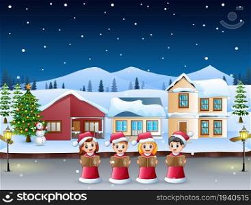 Group of kids in red santa costume singing christmas carols in the snowy village