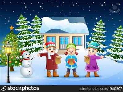 Group of kids in winter clothes singing christmas carols in the snowy village