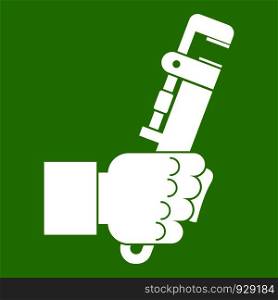 Hacksaw in man hand icon white isolated on green background. Vector illustration. Hacksaw in man hand icon green
