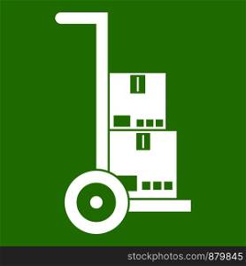 Hand cart with cardboards icon white isolated on green background. Vector illustration. Hand cart with cardboards icon green