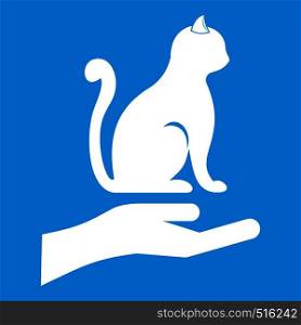 Hand holding a cat icon white isolated on blue background vector illustration. Hand holding a cat icon white