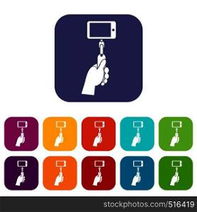 Hand holding a selfie stick with mobile phone icons set vector illustration in flat style in colors red, blue, green, and other. Hand holding a selfie stick with mobile phone set