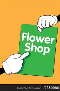 Hand holding banner with Flower Shop text on paper. Man showing billboard.