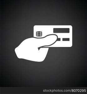 Hand holding credit card icon. Black background with white. Vector illustration.