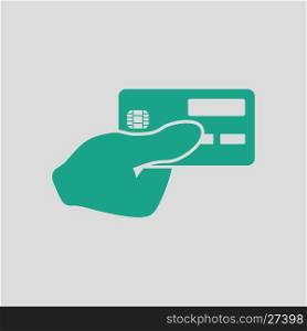 Hand holding credit card icon. Gray background with green. Vector illustration.