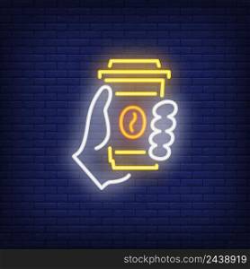 Hand holding disposable coffee cup neon sign. Cafe, break, beverage concept. Advertisement design. Night bright neon sign, colorful billboard, light banner. Vector illustration in neon style.