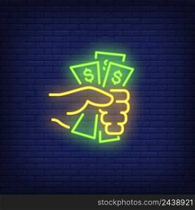 Hand holding dollar bills neon sign. Money, finance and banking concept. Advertisement design. Night bright neon sign, colorful billboard, light banner. Vector illustration in neon style.