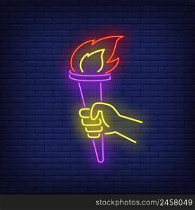 Hand holding flaming torch neon sign. Victory, liberty, power design. Night bright neon sign, colorful billboard, light banner. Vector illustration in neon style.